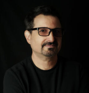 Headshot of Jeff Rona wearing a black t shirt