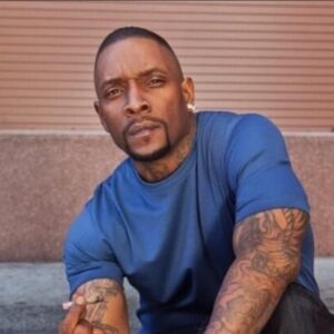 Headshot of Jayo Felony holding a cigarette in his hand