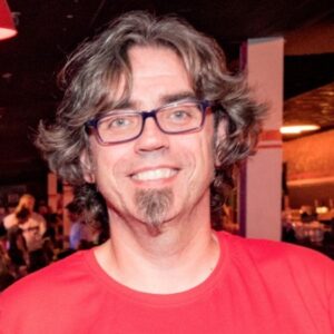 Headshot of David Cortes wearing a red t shirt